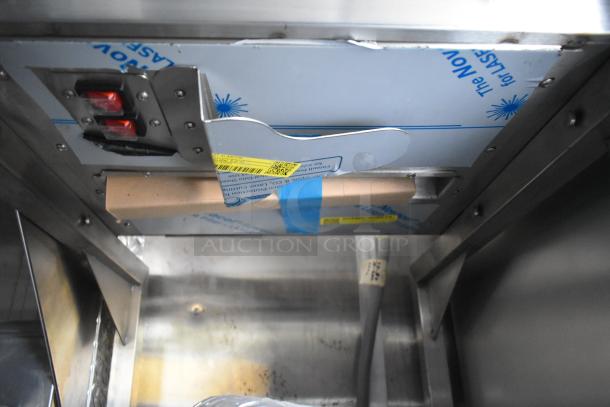 2021 Cruising Kitchens Burger King food trailer interior, featuring protective coverings on equipment, indicating new condition.