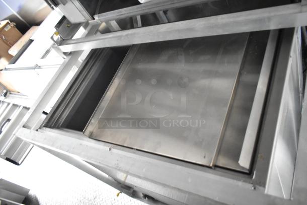 Interior of Cruising Kitchens 24' Burger King trailer, showing stainless steel commercial-grade equipment and storage.