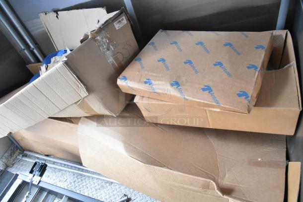 Cardboard boxes labeled "Antunes" inside a Cruising Kitchens trailer. Boxes appear intact, stacked on metal flooring.