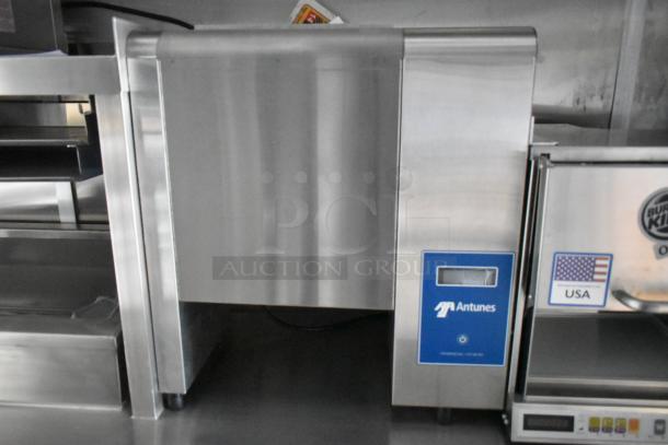 Stainless steel Antunes commercial toaster with digital display, shown in a new condition in a mobile kitchen setup.