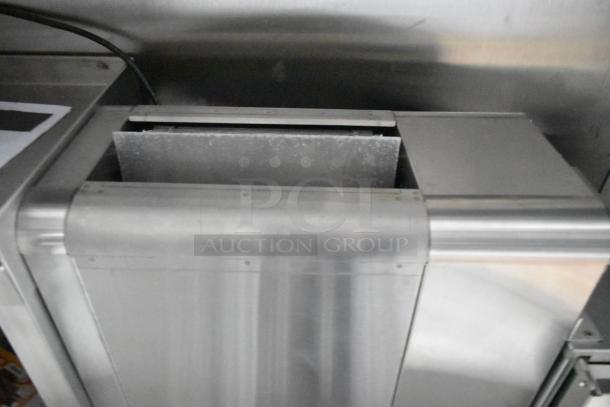 Stainless steel kitchen fixture inside 2021 Cruising Kitchens trailer, part of a commercial-grade mobile kitchen setup.