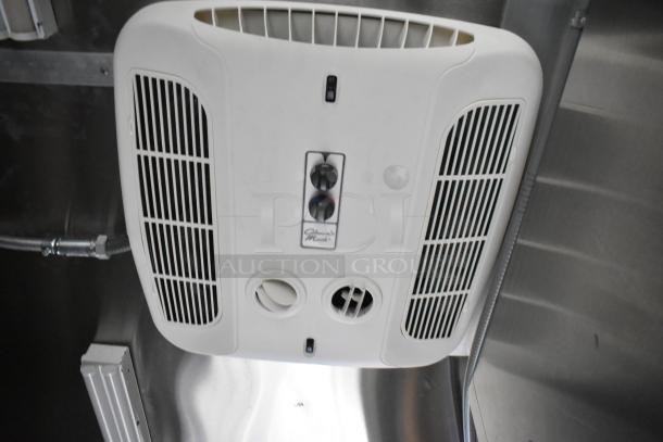 Interior of a Cruising Kitchens mobile kitchen trailer featuring a ceiling-mounted air vent.