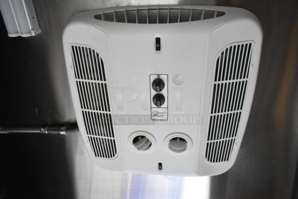 Ceiling-mounted Climatic Mark air conditioning unit with controls shown on the surface, inside a mobile kitchen trailer.