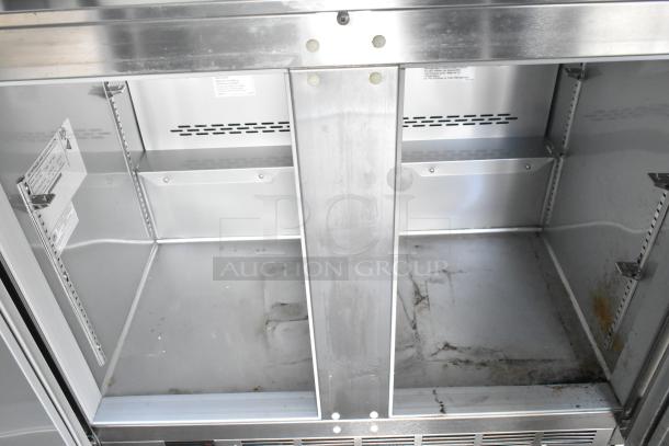 Inside view of a Nationwide mobile trailer with empty shelving. Metal interior shows signs of use.