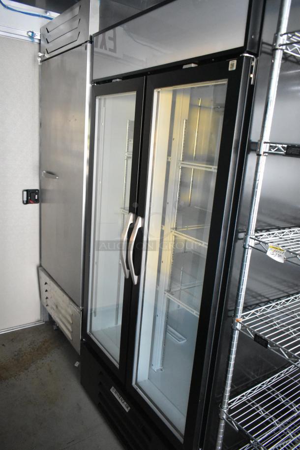 New 2021 Nationwide 24' trailer interior, showing Beverage Air reach-in cooler, freezer, and wire shelving. Mint condition.