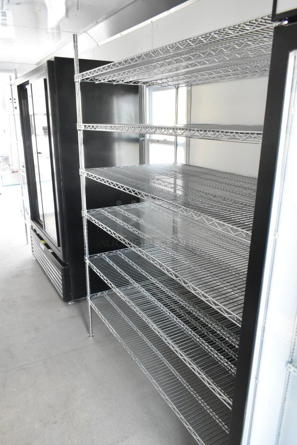 Nationwide 24' trailer interior featuring metal wire shelving and cooling units, ideal for food and beverage retail. Brand new 2021.