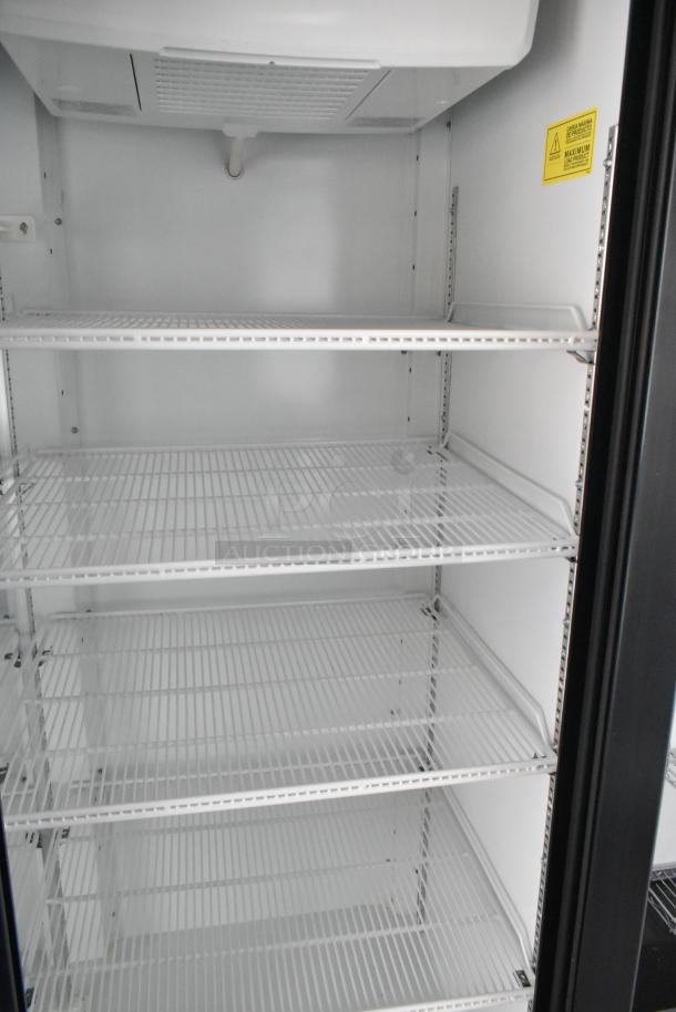 Interior of a Beverage Air reach-in cooler, featuring multiple white wire shelves, ideal for cold storage in a food trailer.