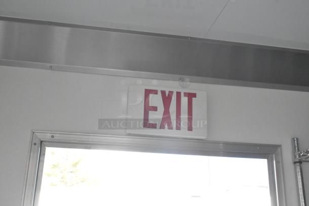 Interior view of a Nationwide 24' trailer with an "Exit" sign above the door. Stainless steel frame visible.