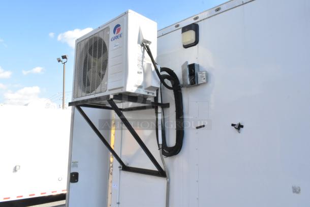 24' Nationwide trailer with Gree air curtain, equipped for cold food/beverage retail. Features robust cooling system.