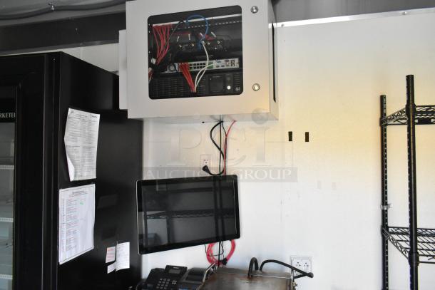 Interior of a 24' cold food retail trailer featuring Beverage Air coolers, POS system, and network equipment cabinet.