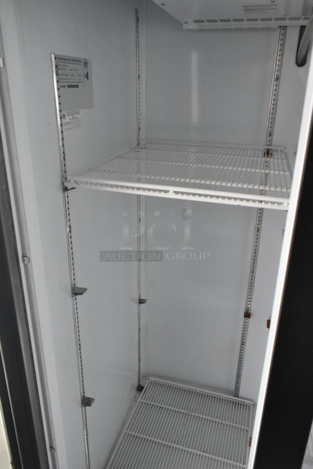 Interior view of a commercial-grade Beverage Air reach-in cooler, featuring adjustable wire shelves and a clean, unused condition.