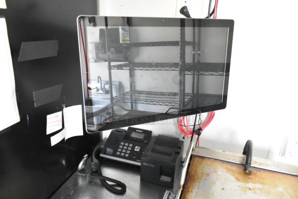 Interior view of a Nationwide retail trailer featuring a POS system, phone, and metal shelves. Part of a fully equipped setup.