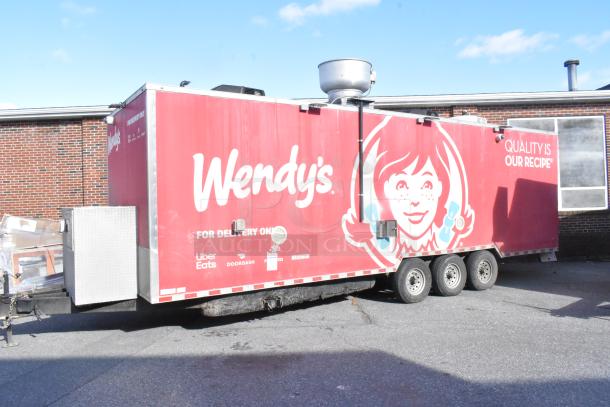 Wendy's branded mobile kitchen trailer, red exterior, features food delivery logos, triple axle, rooftop vent, "Quality is Our Recipe" slogan.