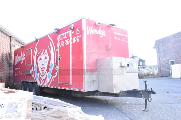 Red Wendy's mobile kitchen trailer with logo, slogan, and delivery partner logos. Good condition, equipped for food service.