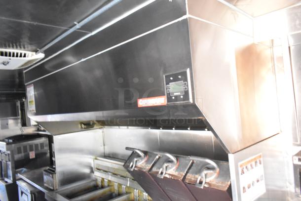 Commercial kitchen range hood with stainless steel finish and CaptiveAire branding, featuring integrated controls and a clean appearance.