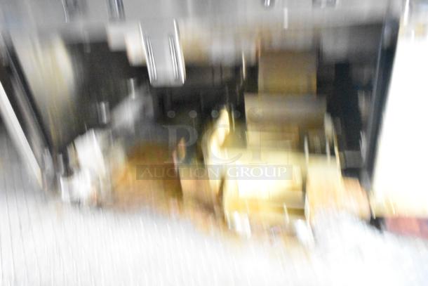 Blurry image with metallic and golden tones, details unclear. Item unidentified.