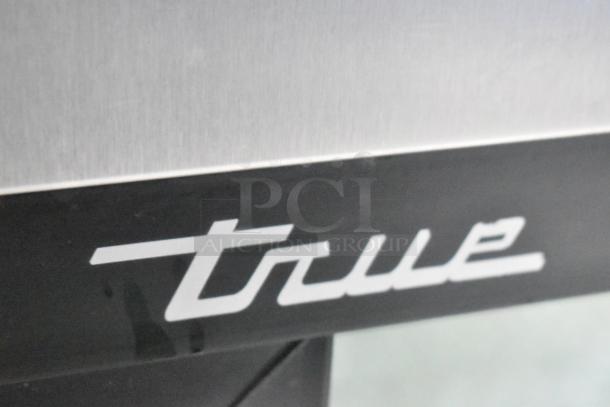 Close-up of True brand logo on a stainless steel surface, indicating high-quality craftsmanship.