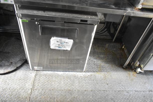 Stainless steel under-counter freezer, visible sign reading "FRENCH FRIES." Used condition with surface wear.