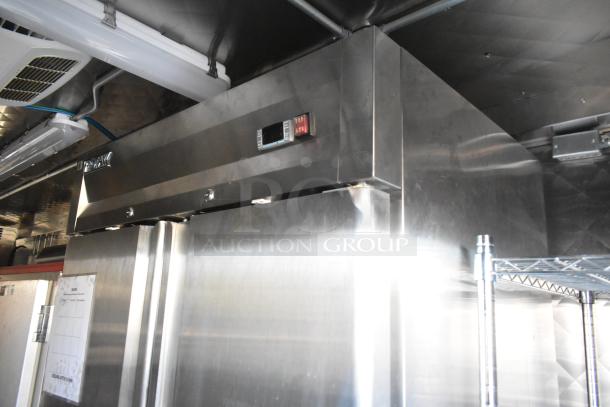 Commercial stainless steel freezer with digital temperature display, excellent condition, large storage capacity.