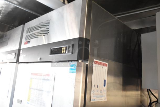 Commercial stainless steel refrigerator, Energy Star certified, with temperature control panel and maintenance stickers, good condition.