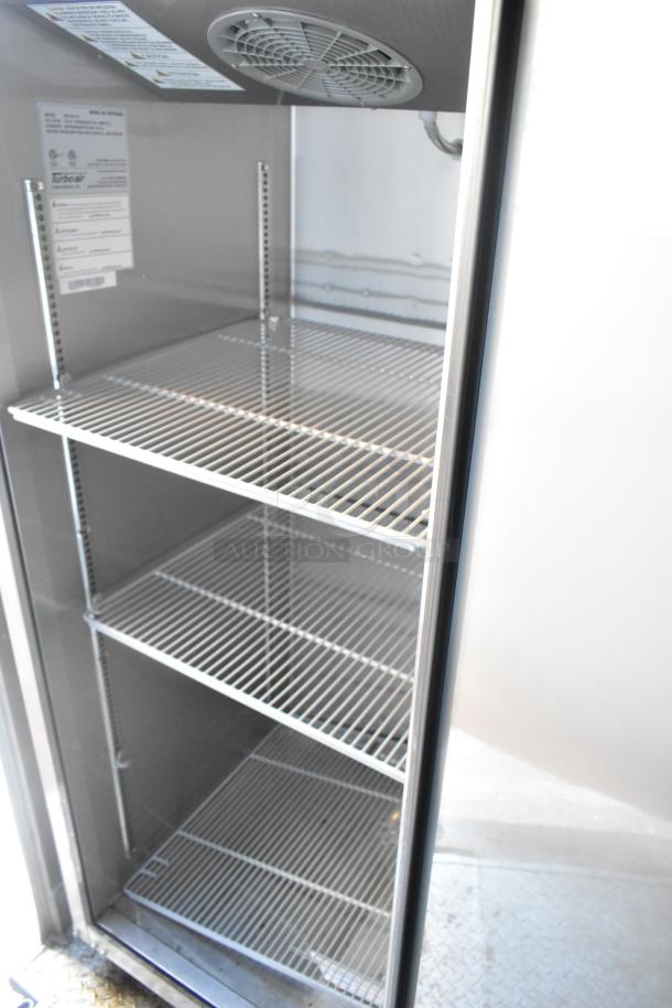 Commercial refrigerator interior with wire shelves, Turbo Air label visible, indicating model and specifications, good condition.
