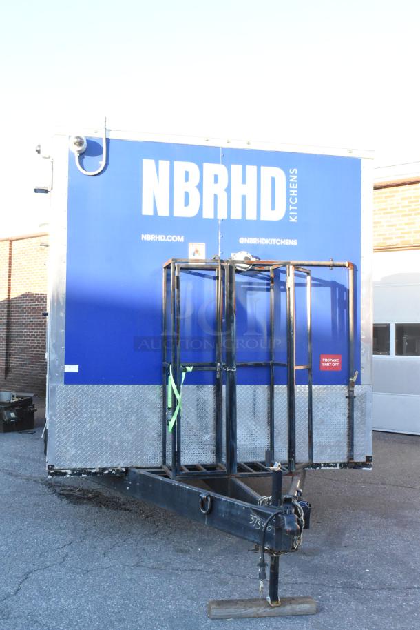 Cruising Kitchens 24' fast food trailer, blue exterior with "NBRHD KITCHENS" branding, propane shut-off label visible.