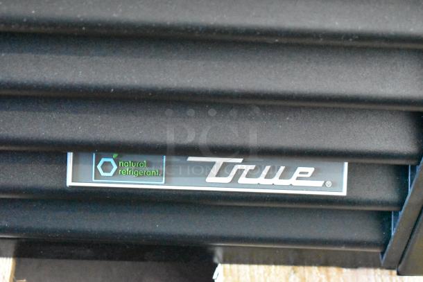 Brand new 2025 True TVM-48SL-HC commercial cooler, 2-door, metal, 115V, 1 phase. "Natural refrigerant" label visible.