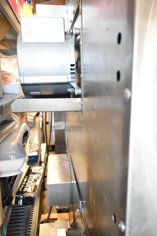 Southbend PCE75S/SD convection oven side view, shows stainless steel exterior, part of fan system, and metal infrastructure.