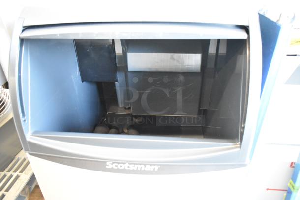 Scotsman UN1520AX-1A stainless steel undercounter nugget ice machine, brand new with 57 lb. bin, 115V, minor dents visible.