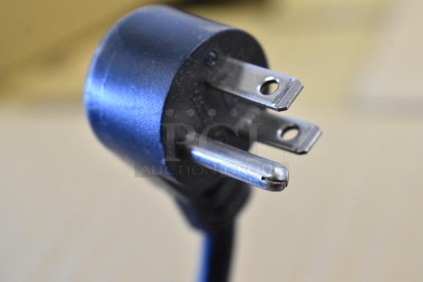 Close-up of a three-prong electrical plug for the 2019 Delfield 406P-STAR2 stainless steel undercounter cooler.