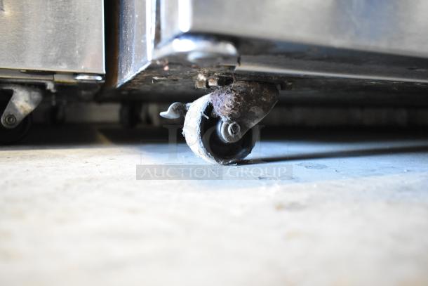 2018 Delfield UC4048P-STAR undercounter cooler on worn commercial caster, stainless steel, 115V, 1 phase.