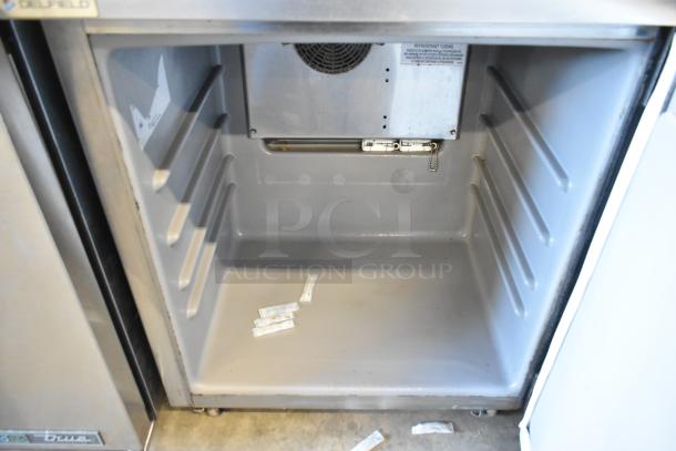 Delfield stainless steel undercounter cooler, single door, on casters, 115 volts, excellent condition, interior view shown.