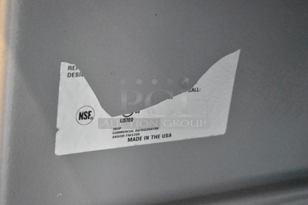 Delfield stainless steel undercounter cooler label, NSF certified, 115V, 1 phase, made in USA, on commercial casters.