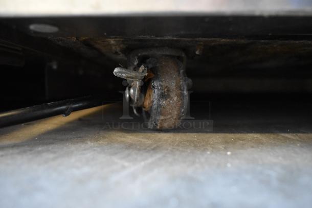 Delfield stainless steel undercounter cooler caster, worn condition, on commercial caster. 115 volts, 1 phase power.