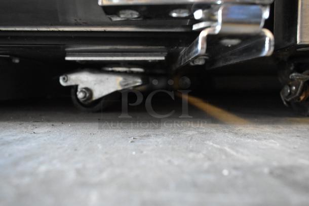 2023 True TUC-27-HC undercounter cooler on commercial casters, stainless steel, 115V, 1 Phase, close-up of casters.