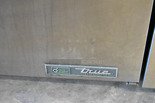 2023 True TUC-27-HC undercounter cooler, stainless steel with label. Features commercial casters, 115V, 1 Phase.