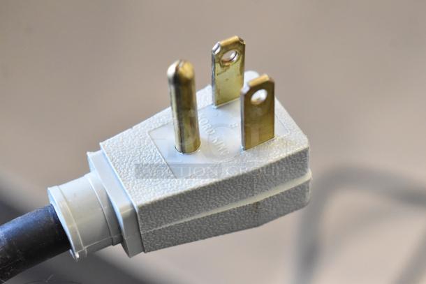 Close-up image of a power plug for a commercial cooler. Reads "KORD KING" on the plug surface.