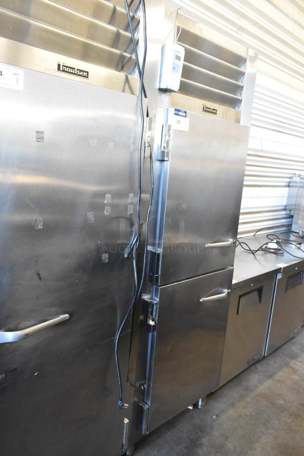 Traulsen RHT132WREHHS stainless steel 2 half-size door reach-in cooler, 115V, 1 phase, used condition with visible markings.