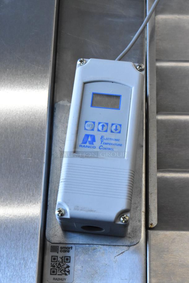 Alt text: Ranco electronic temperature control panel on Traulsen stainless steel cooler, model RHT132WREHHS, with Smart Care QR code.