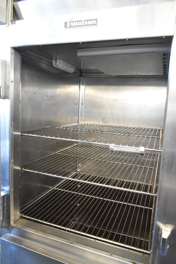Traulsen RHT132WREHHS stainless steel reach-in cooler with two half doors, wire shelves, and 115V, 1-phase power.