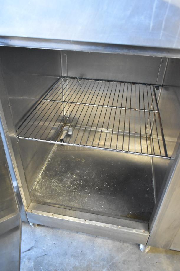 Traulsen RHT132WREHHS stainless steel reach-in cooler, two half doors, 115V, 1 phase, interior view with wire shelf.