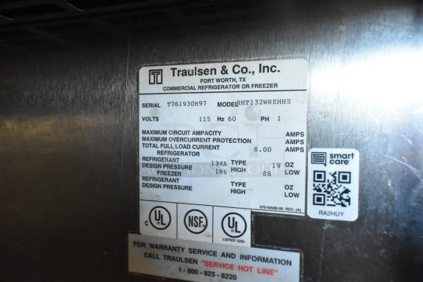 Traulsen RHT132WREHHS stainless steel reach-in cooler, 2 half-size doors, 115V, 1 phase, label with specs visible.