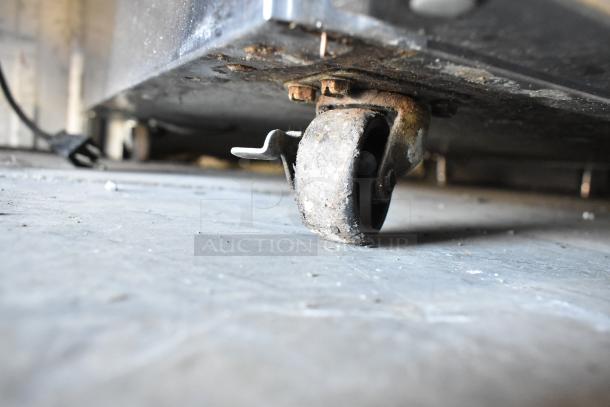 2018 Delfield 406P-STAR2 stainless steel undercounter cooler on commercial caster. 115V, 1 Phase. Shows wear on wheel.