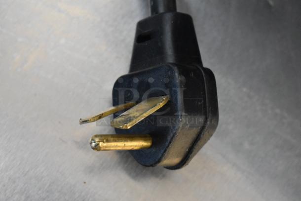 Close-up of a damaged power plug for a Merrychef eikon e2s electric rapid cook oven.