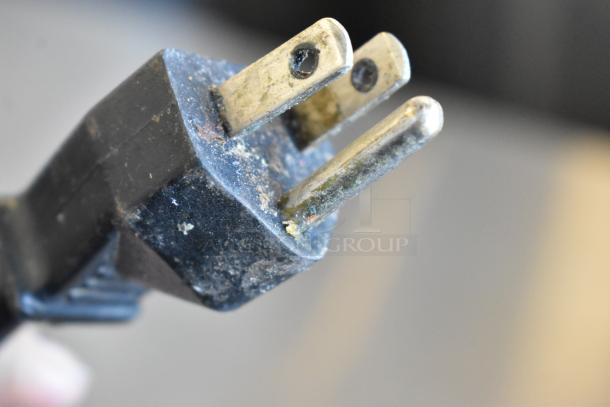 Robot Coupe R2U metal food processor plug, close-up view, visible wear and patina.