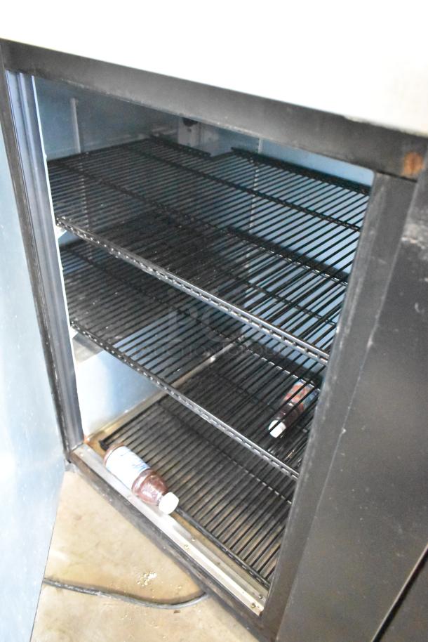 2017 True TBB-4-HC commercial 3-door back bar cooler, metal exterior, shelving units, 115 volts, used condition.