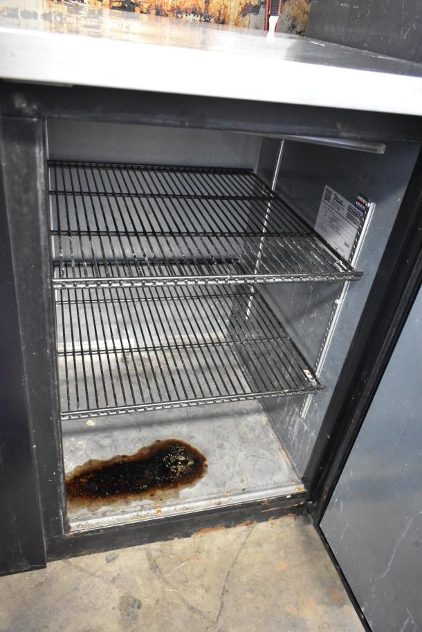 2017 True TBB-4-HC commercial 3-door back bar cooler, 115 volts, visible interior rust and spill, model label present.