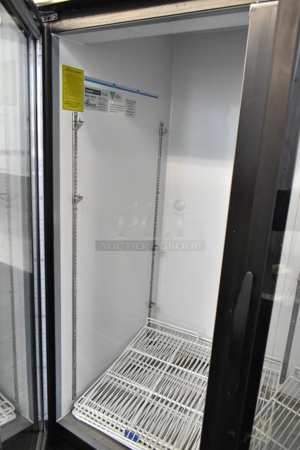 Central 69K-056 metal commercial 3-door reach-in cooler with poly-coated racks, labeled, 115V, 1 phase.