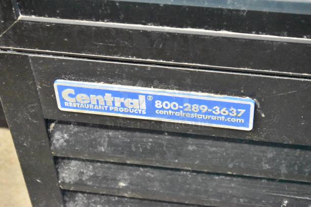 Central 69K-056 3-door reach-in cooler with black exterior. Features poly-coated racks, Central brand label visible.