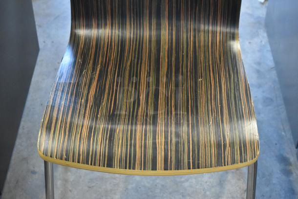 Wood-patterned dining chair with metal legs, sleek design. Some wear visible on the surface. Bundle of 5 chairs.